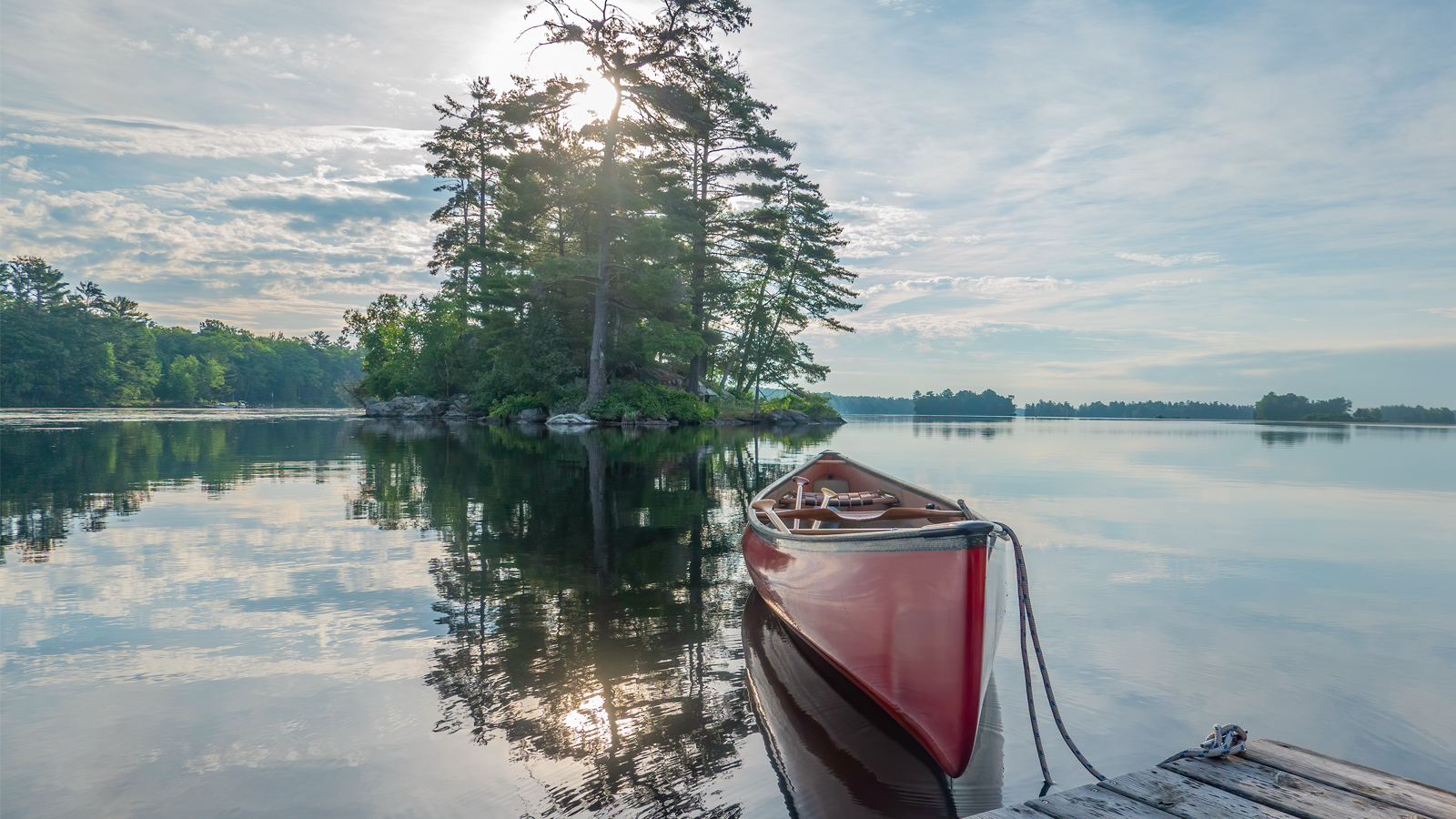 Canoe floating on calm lake